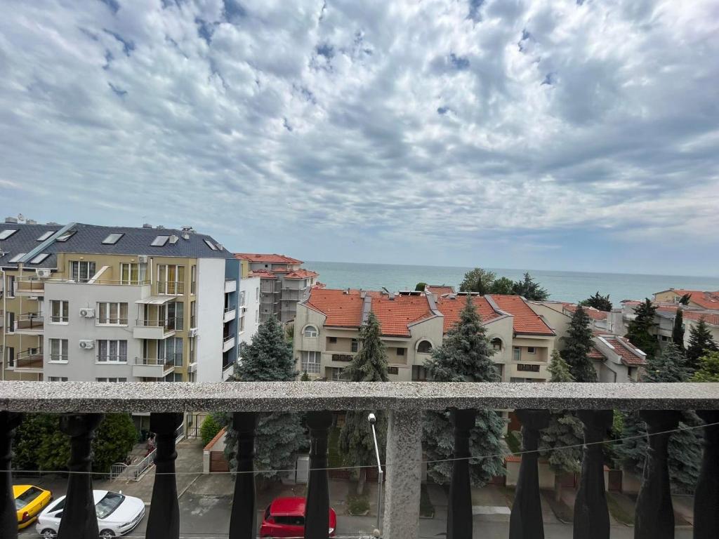a view from a balcony of buildings and the ocean at Апарт Хотел Мари in Ravda