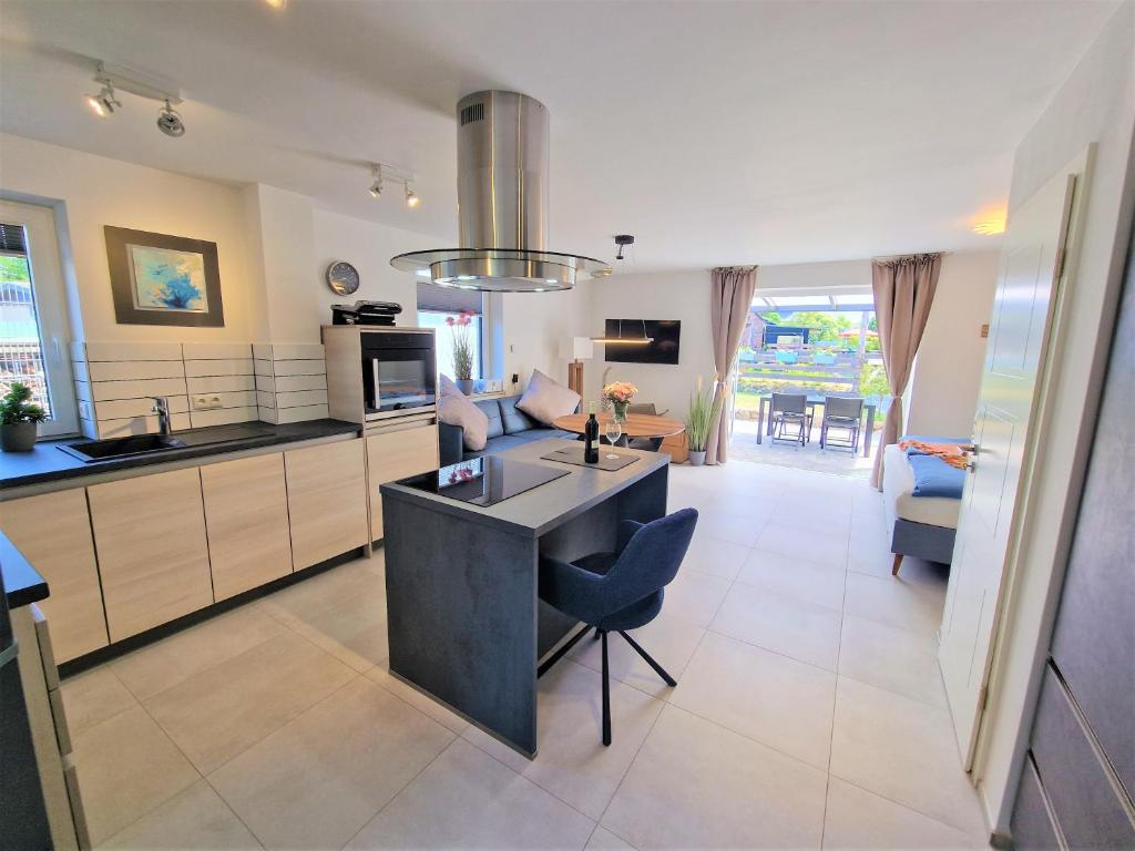 a kitchen with a island in the middle of a room at # Urlaubsreif in Zierow