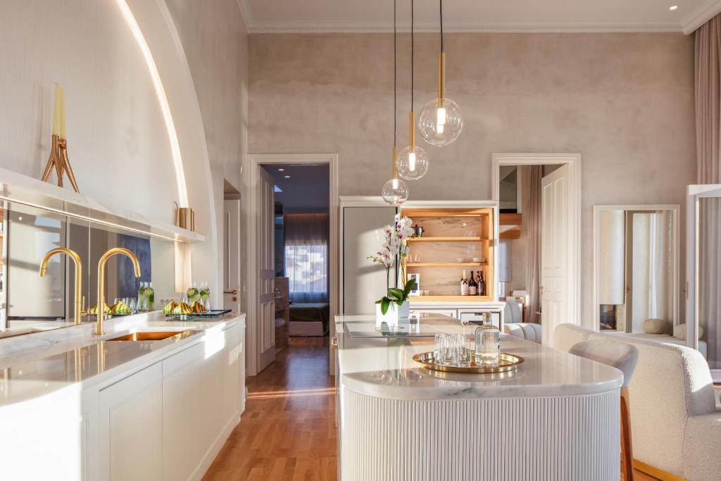 a kitchen with a white island in a room at La Torre Residenza Imperiale in Chania