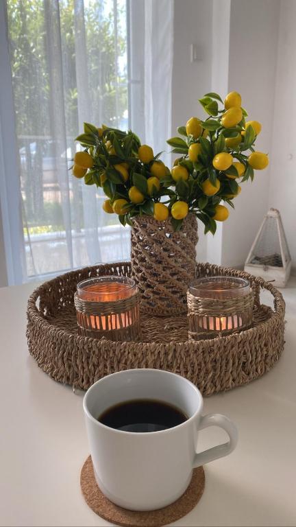a cup of coffee on a table with a plant at Serenity Apart in Antalya