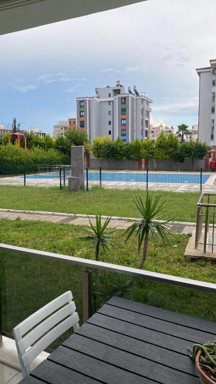 a balcony with a table and a view of a park at Serenity Apart in Antalya