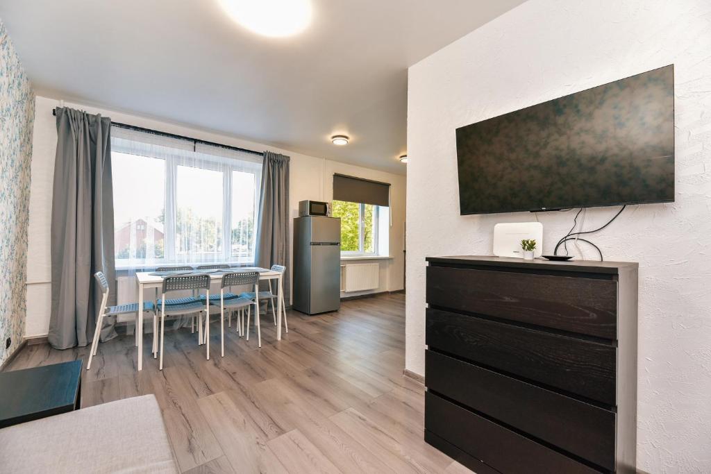 a living room with a kitchen and a dining room at King Petera in Ventspils