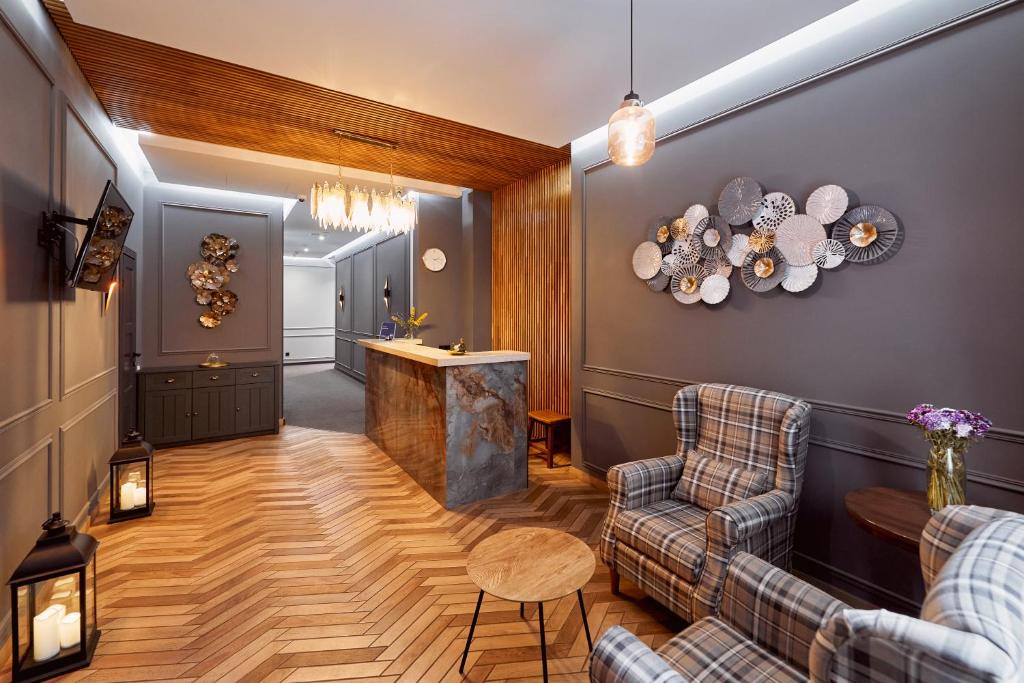 a living room with two couches and a bar at Hotel Classic in Kyiv