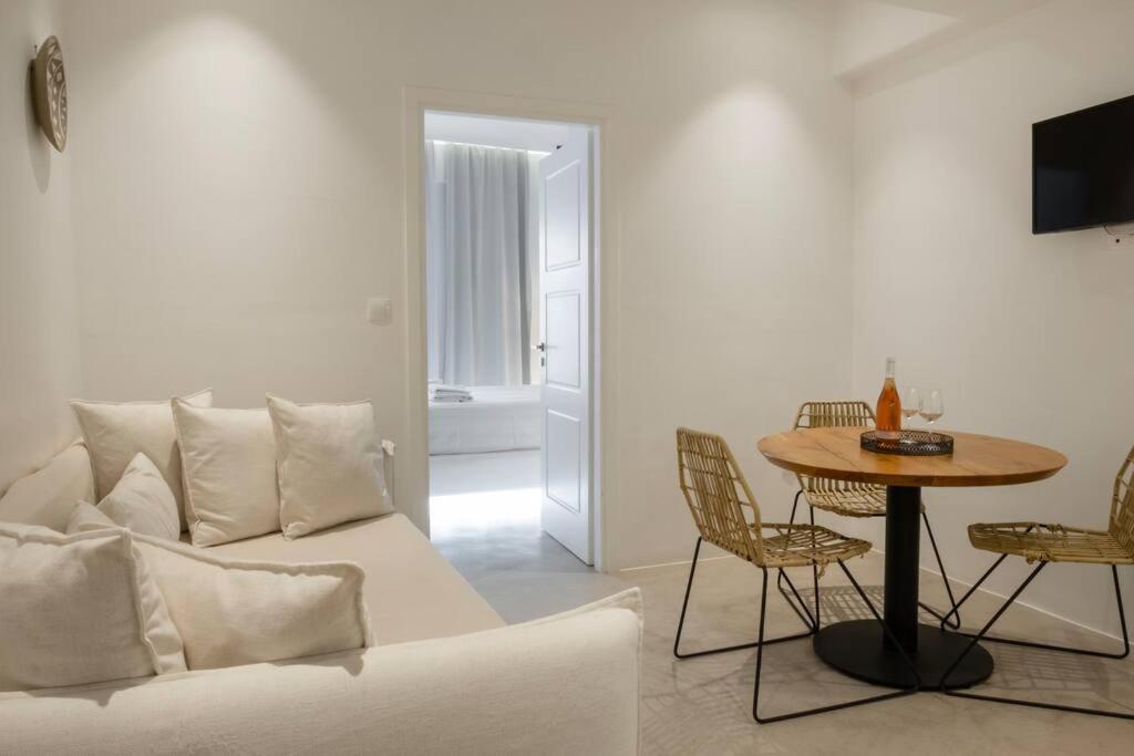 a living room with a couch and a table at Luxury Apartment Center of Mykonos Town - Sleeps 3 in Mýkonos City