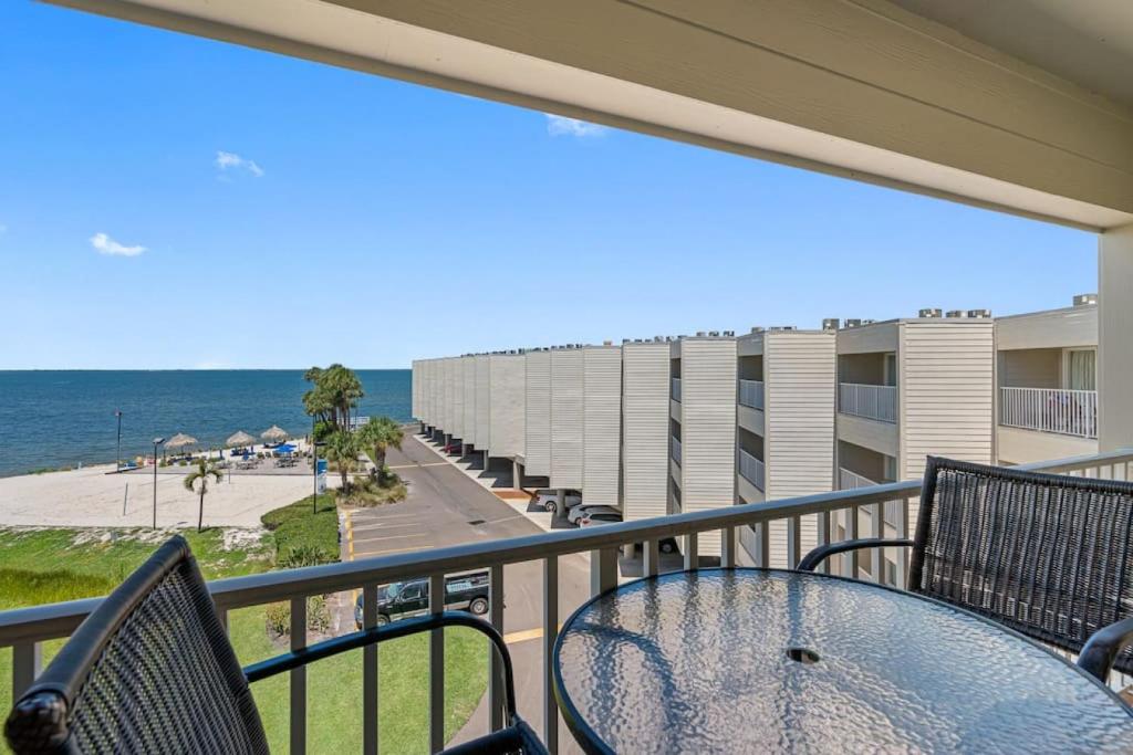 a balcony with a table and chairs and the beach at Stunning Bay Views from your Private Balcony in Tampa