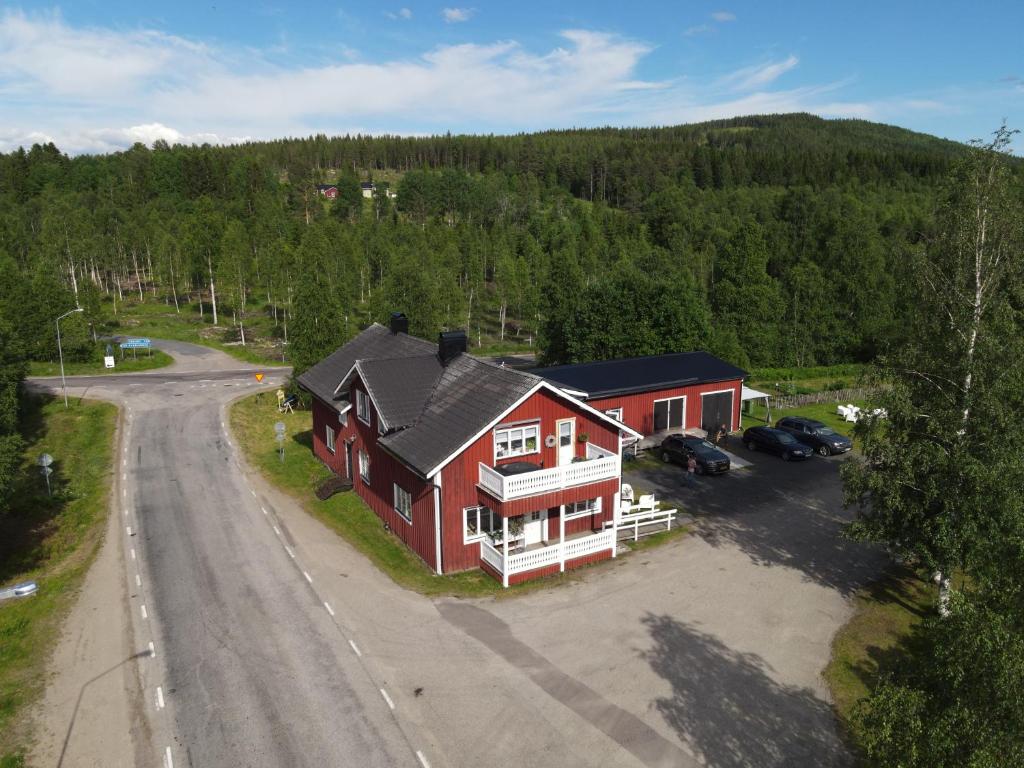 an aerial view of a red house with a parking lot at Swedish Adventure in Brograngen