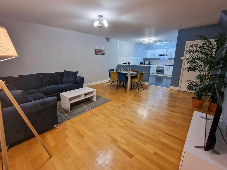 a living room with a couch and a table at Canal Street Apartment in Manchester