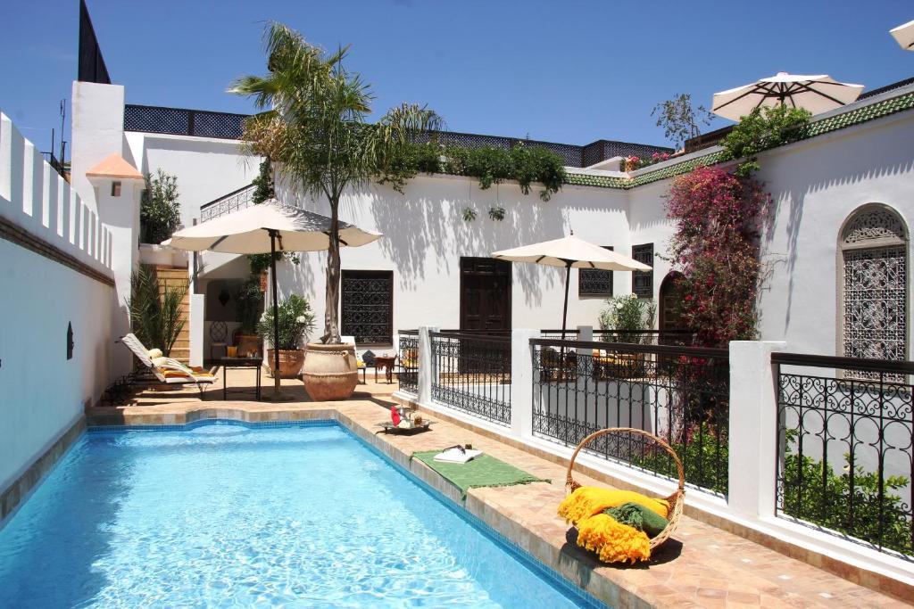 una piscina nel cortile di una casa di Riad Clémentine a Marrakech