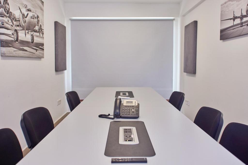 a conference room with a table with a phone on it at Aero Club of East Africa in Nairobi