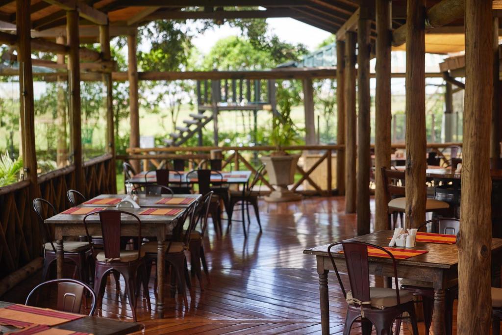 a restaurant with wooden tables and chairs and a wooden floor at Aero Club of East Africa in Nairobi
