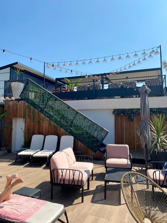 a group of chairs and tables on a patio at Les Alcyons in Le Lavandou