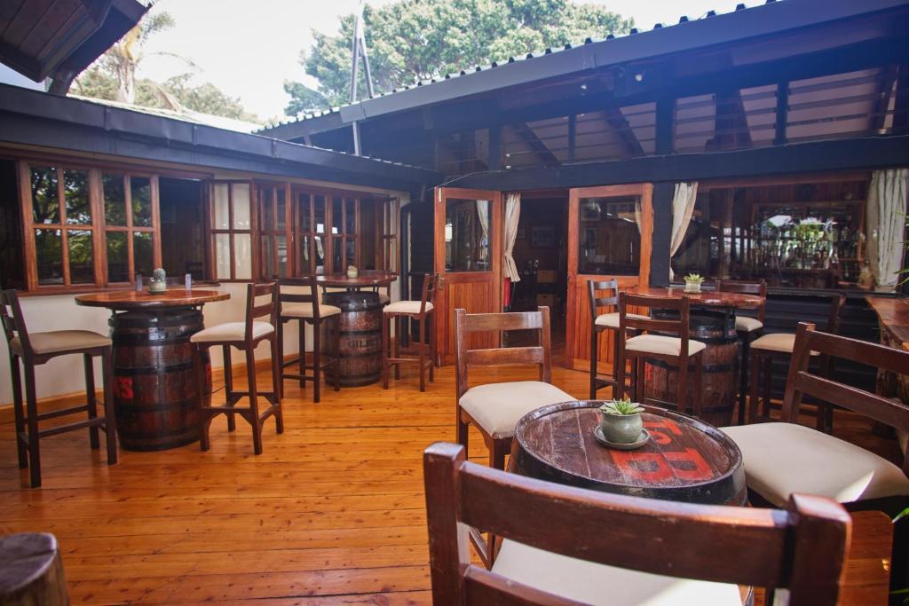 a restaurant with wooden floors and tables and chairs at Aero Club of East Africa in Nairobi