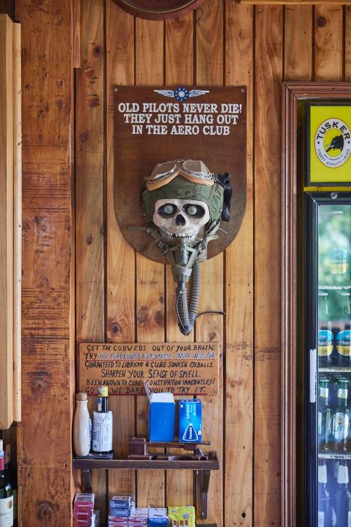 a wall with a hat and a sign on it at Aero Club of East Africa in Nairobi