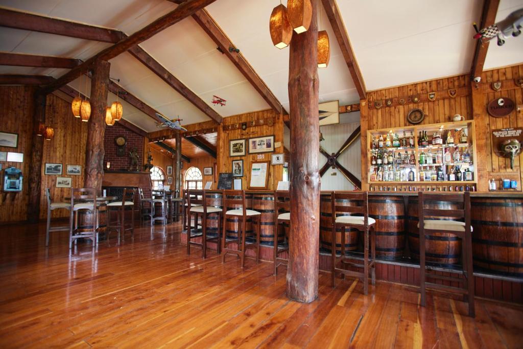 a bar with wooden floors and bar stools at Aero Club of East Africa in Nairobi