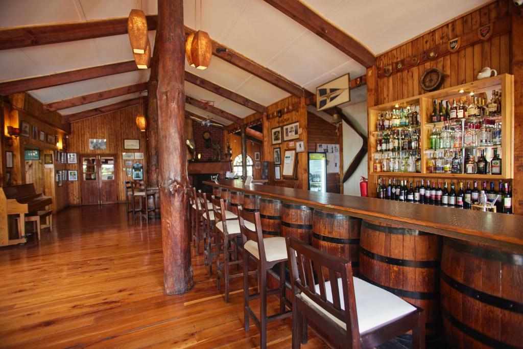 a bar in a restaurant with wooden walls and wooden floors at Aero Club of East Africa in Nairobi