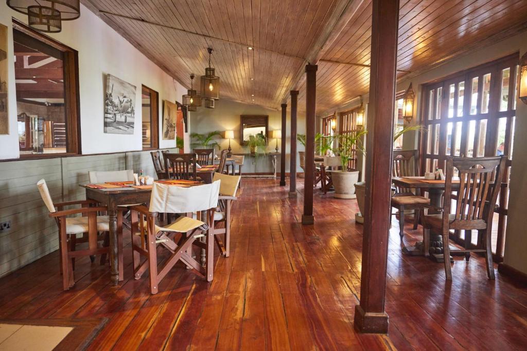 a dining room with wooden tables and chairs at Aero Club of East Africa in Nairobi