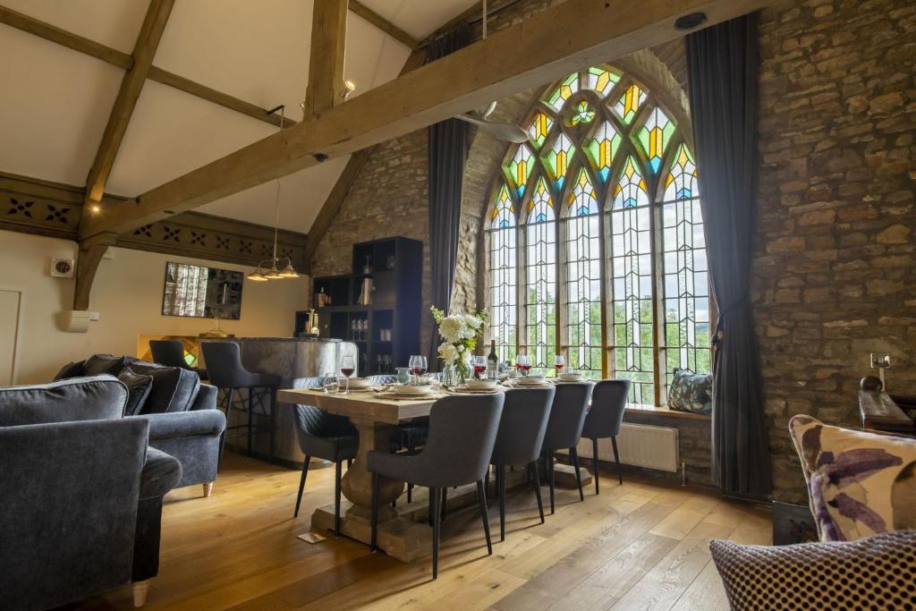 a dining room with a table and chairs and a window at Askrigg Chapel in Askrigg