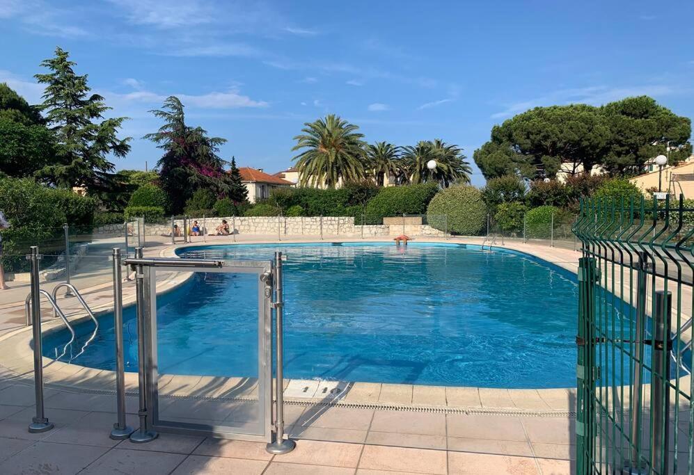 a large swimming pool with blue water at Antibes 2P RDJ Parc Velusine piscine tennis in Antibes
