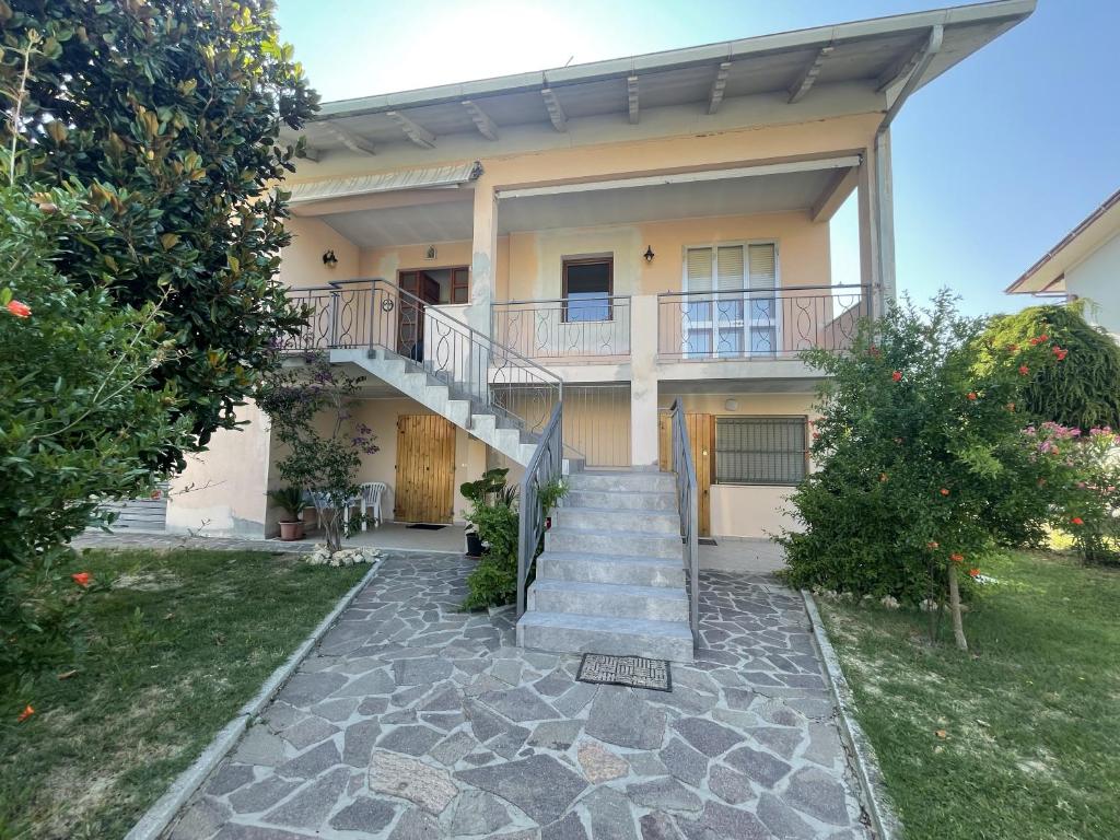 a house with a staircase in front of it at Oasi di Relax in Santa Maria di Scacciano