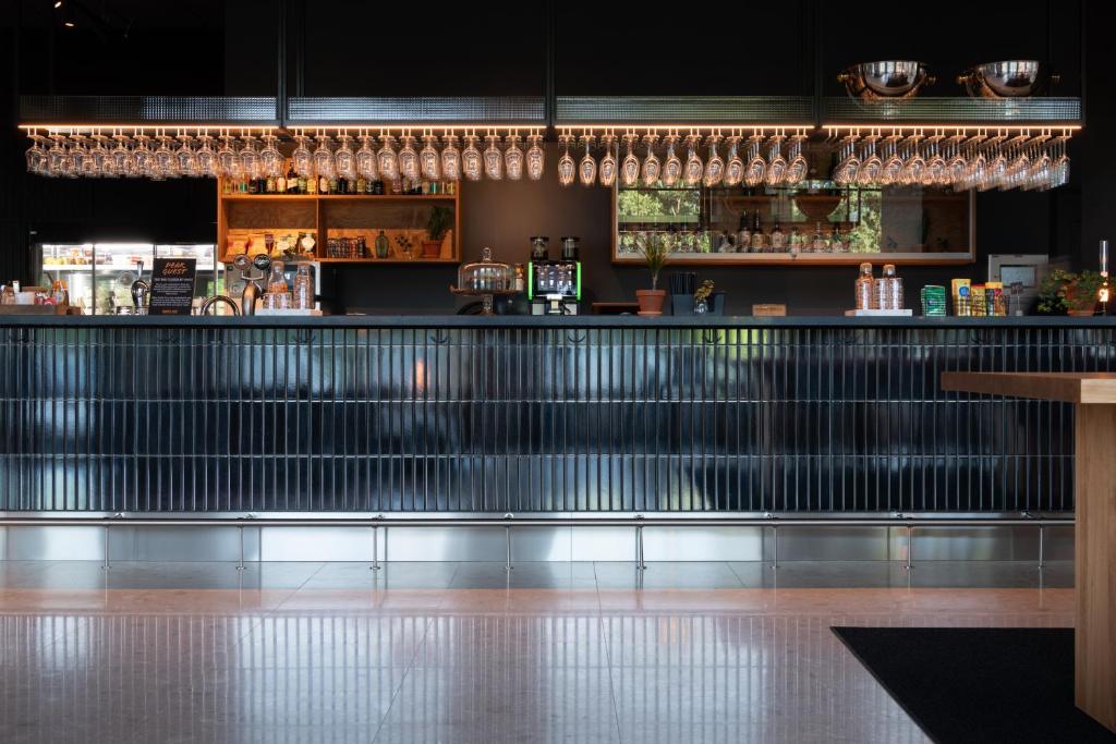 a bar in a restaurant with a counter at Comfort Hotel Solna Arenastaden in Solna