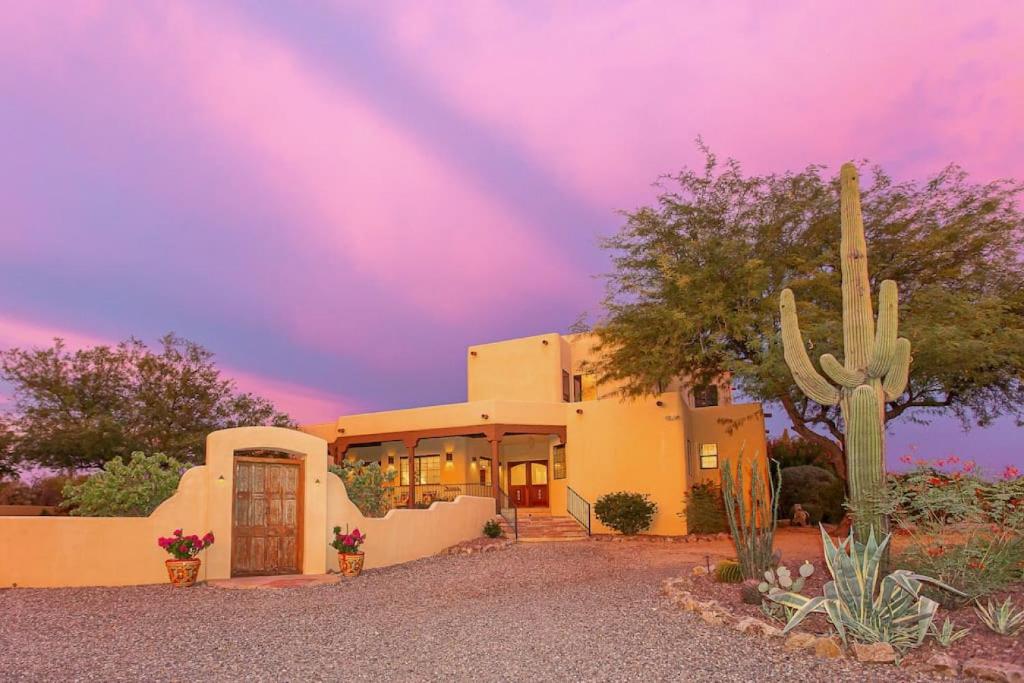 a house with a cactus in front of it at Spectacular Views, Heated Pool, and Outdoor BBQ in Tucson