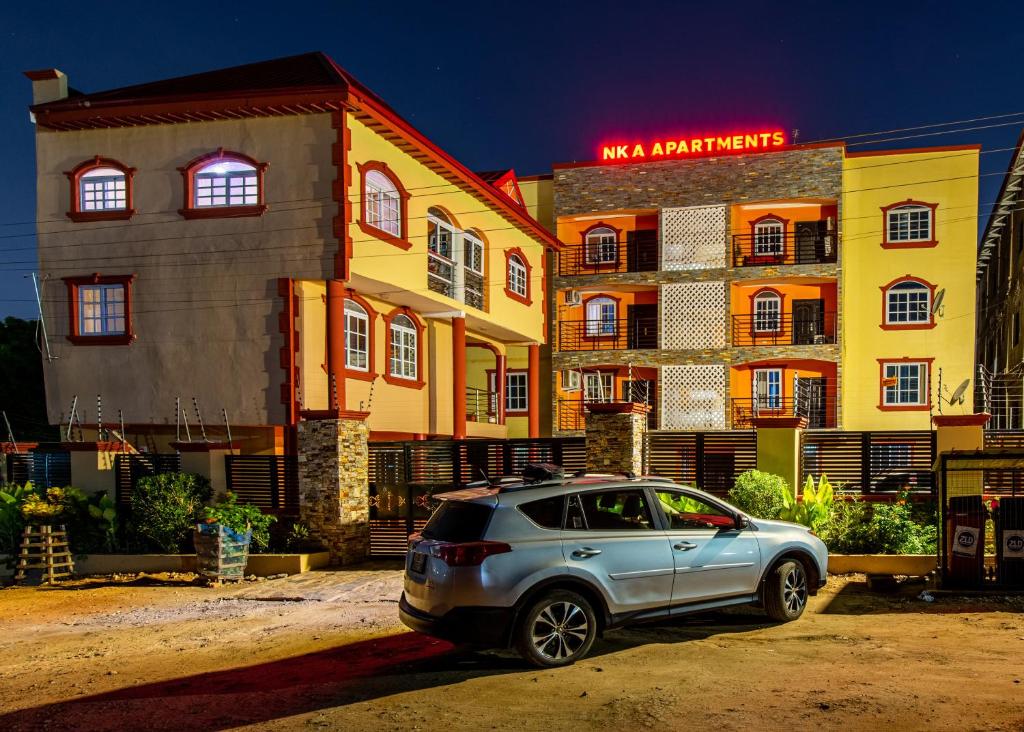 a silver car parked in front of a building at NKA Properties in Apenkwa