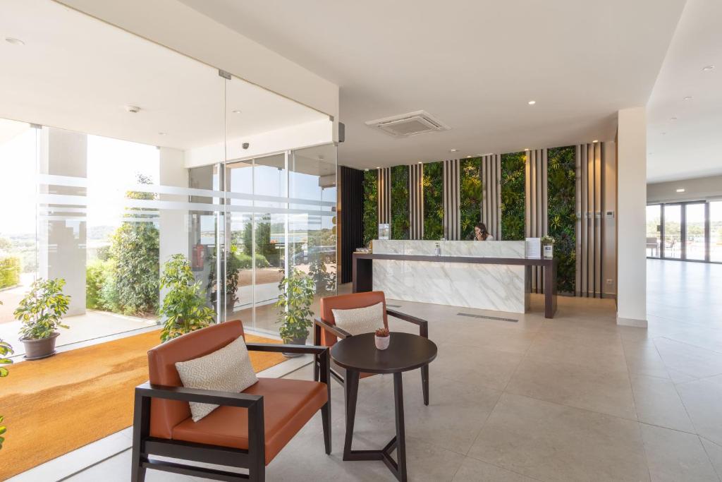 a living room with a table and chairs at Herdade dos Delgados in Mourão