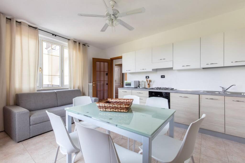 a kitchen and dining room with a table and chairs at GARDASUN 2 Lovely flat Lake close Pet friendly in Padenghe sul Garda