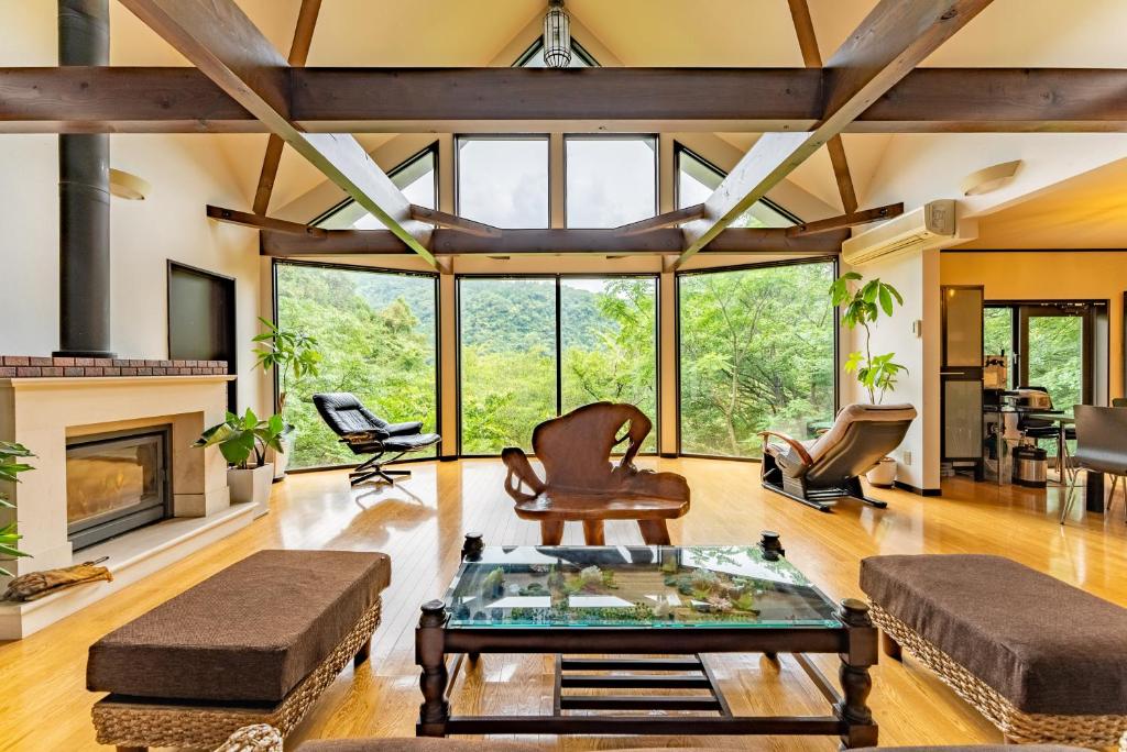 a living room with a vaulted ceiling and large windows at HAYATO HAKONE GUEST HOUSE in Hakone