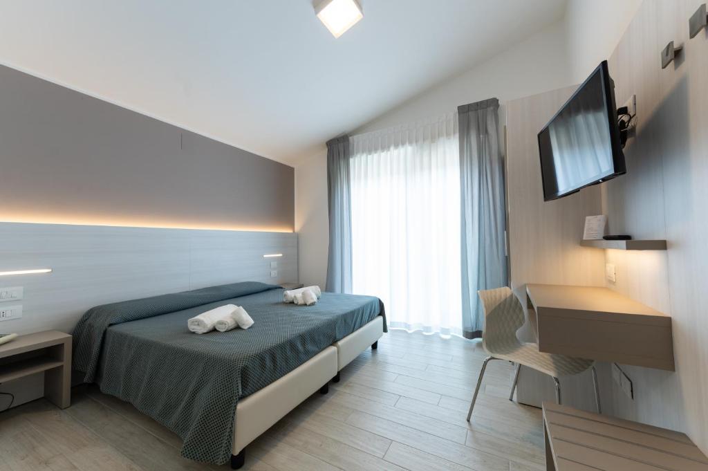 Postel nebo postele na pokoji v ubytování Hotel La Bussola