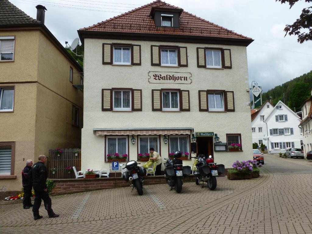 a building with two motorcycles parked in front of it at Gasthaus Waldhorn in Bad Teinach-Zavelstein
