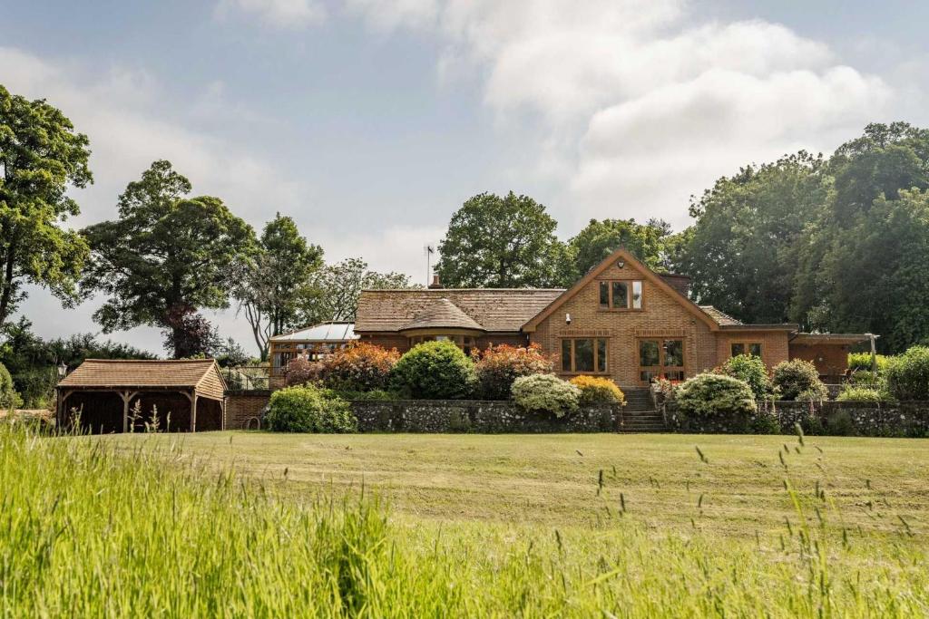 a house with a field in front of it at Millwood in Horstead