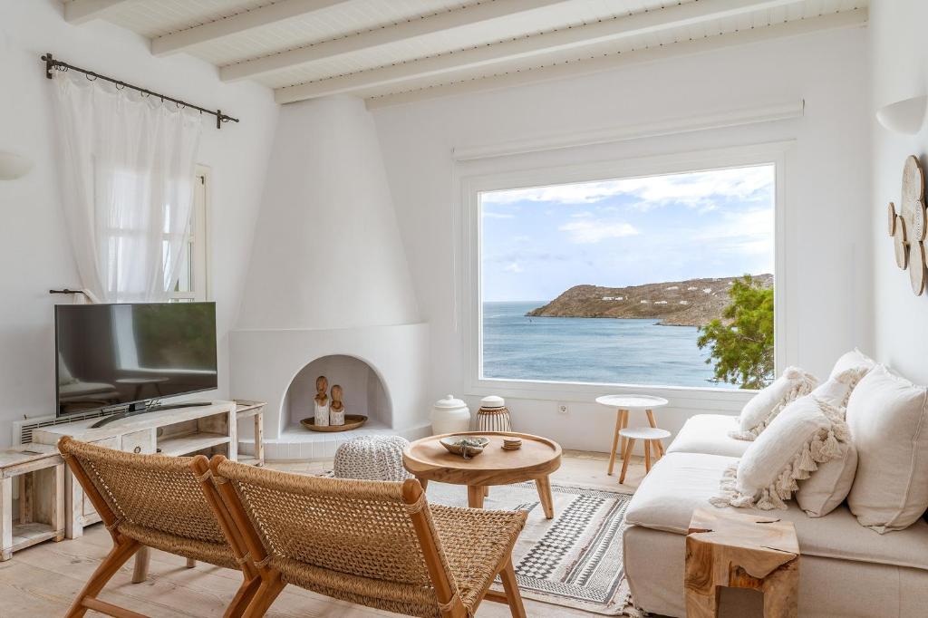 a living room with a view of the ocean at Calma Beach House in Elia Beach