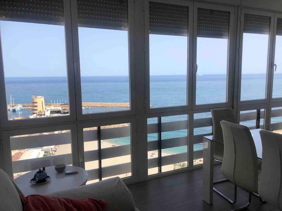 a living room with a view of the ocean at PRIMERA LÍNEA DE PLAYA, LA ARENA A TUS PIES in Aguadulce