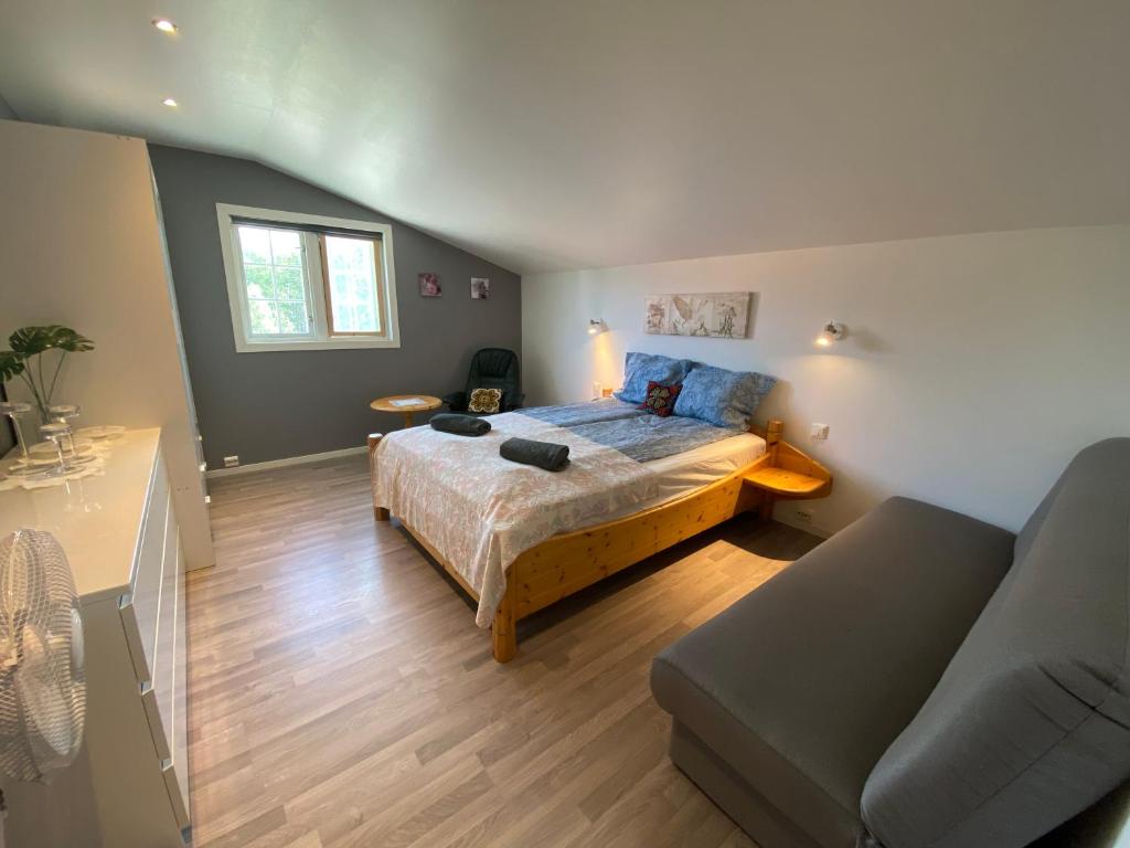 a bedroom with a bed and a couch at Leilighet Sølendet, i Brekken ved Røros in Røros