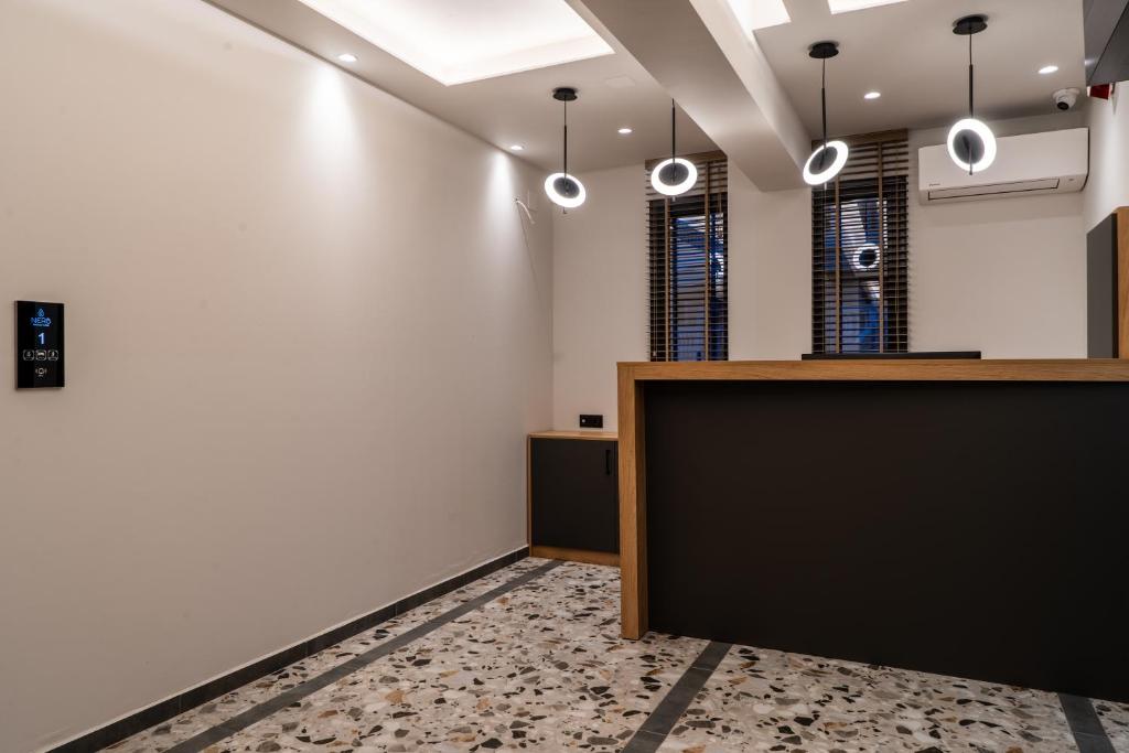 an office with a reception desk and pendant lights at NERO SEASCAPE SUITES in Fanari