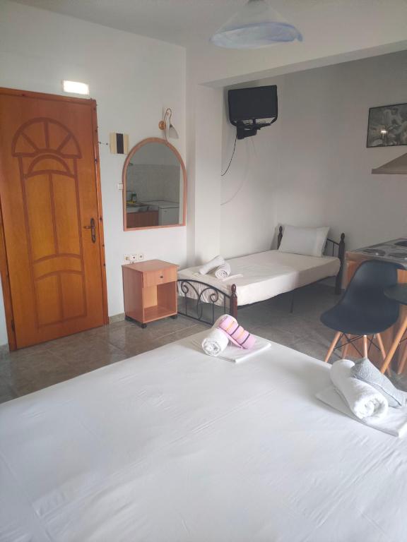 a bedroom with a bed and a room with a tv at Vigla House in Sykia Chalkidikis