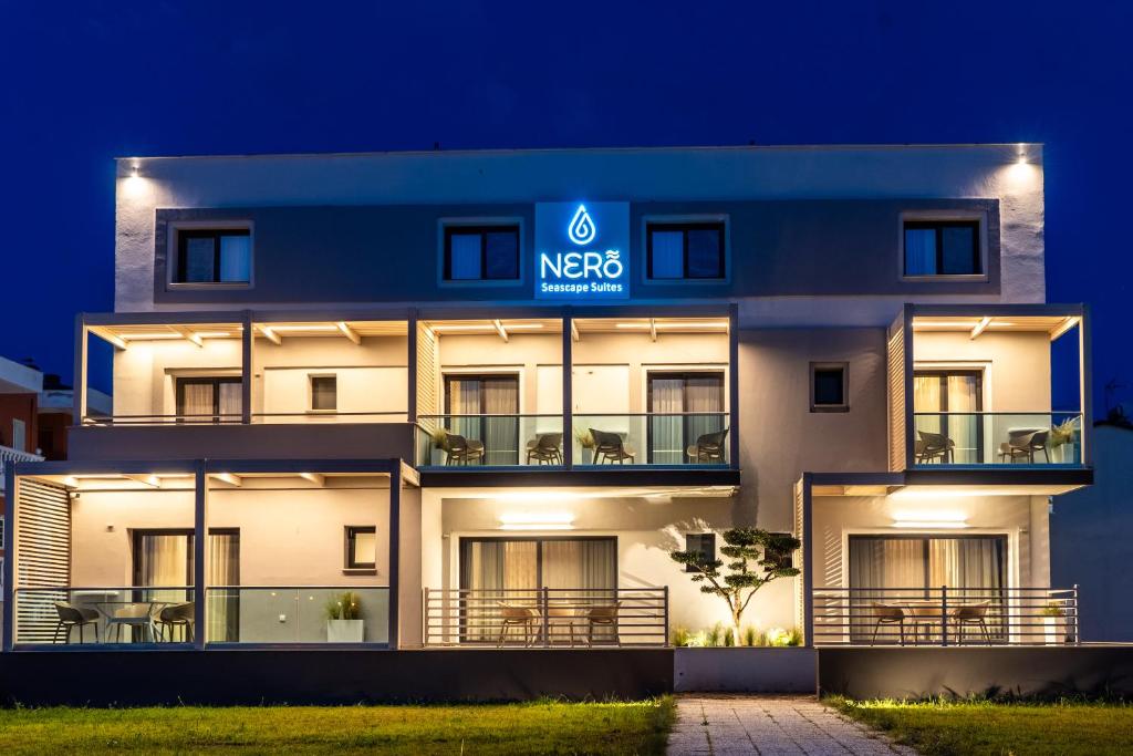 a building with the metro sign lit up at night at NERO SEASCAPE SUITES in Fanari