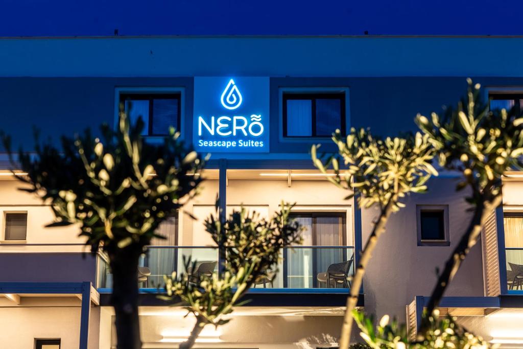 a blue building with trees in front of it at NERO SEASCAPE SUITES in Fanari