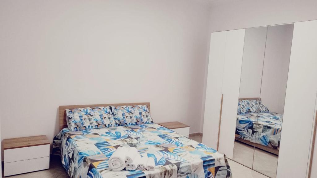 a bedroom with a bed and a mirror at Lovin Puglia Vacation in Bari