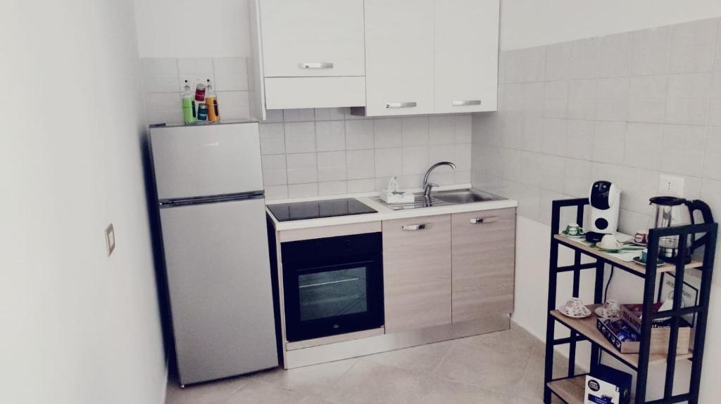 a kitchen with a white refrigerator and a sink at Lovin Puglia Vacation in Bari