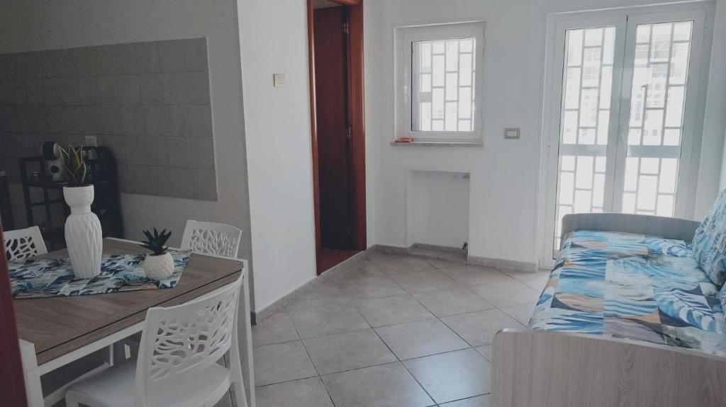 a room with a bed and a table and chairs at Lovin Puglia Vacation in Bari