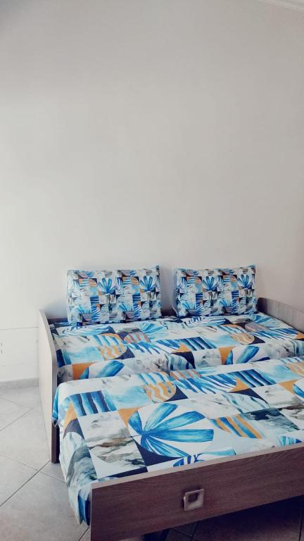 a bed with a blue comforter and pillows at Lovin Puglia Vacation in Bari