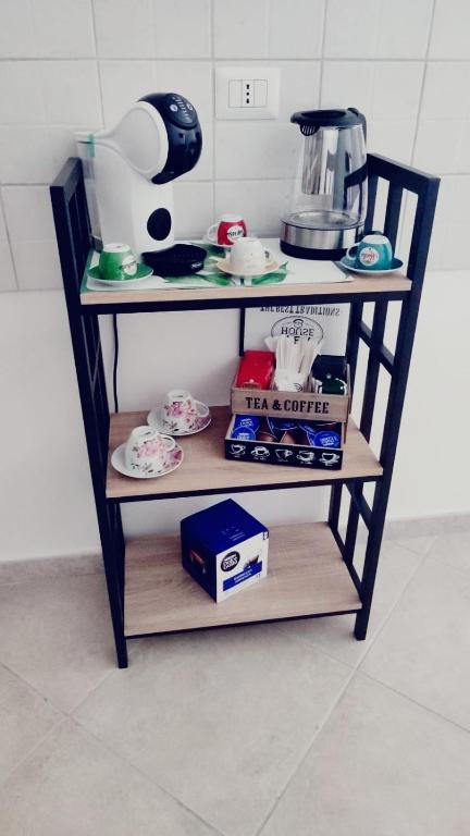 a shelf with dishes and a blender on it at Lovin Puglia Vacation in Bari