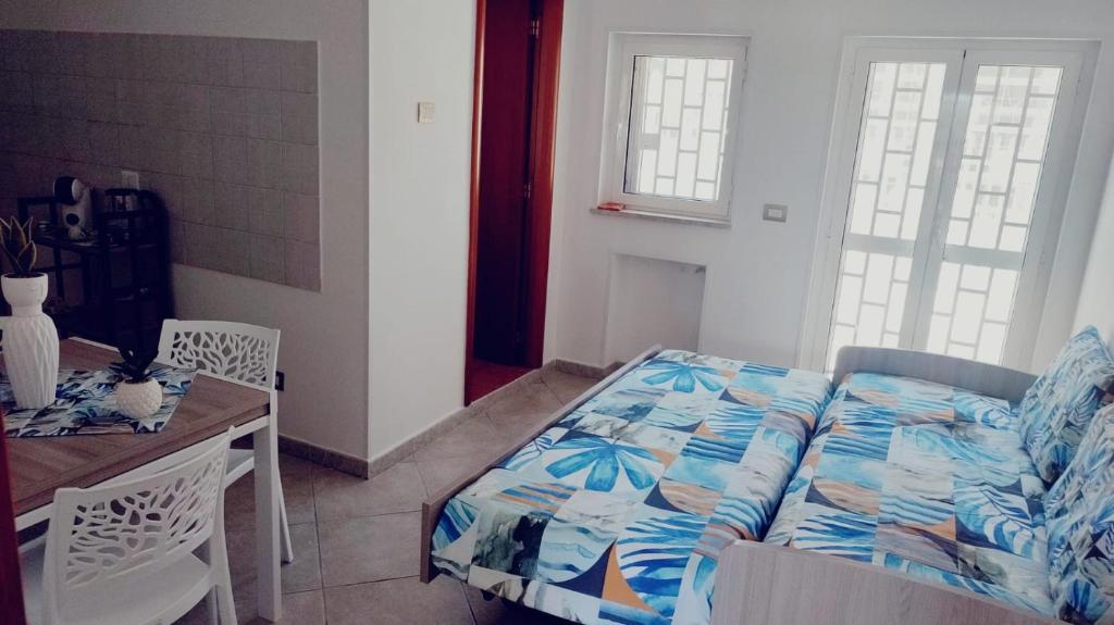 a bedroom with a bed and a table and chairs at Lovin Puglia Vacation in Bari