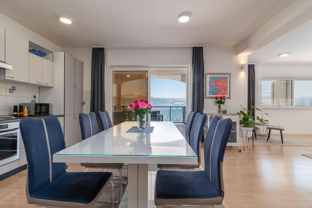 a kitchen and dining room with a table and chairs at Beachfront Apartment with parking in Slatine