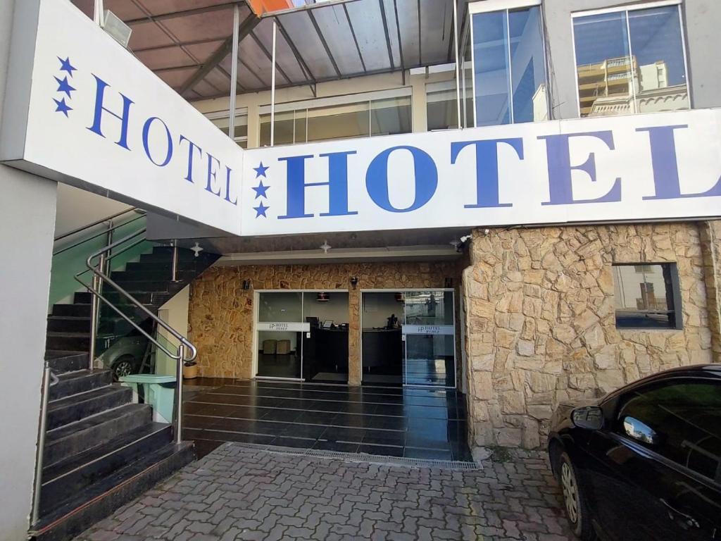 a hotel sign on the front of a building at Hotel Perez in Pouso Alegre