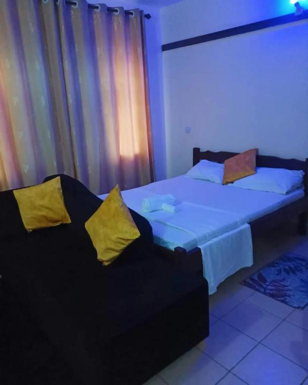 Postel nebo postele na pokoji v ubytování Mkombodzi Global Homes