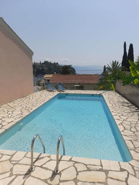 a swimming pool in the middle of a house at Villa Lemonia in Kalami
