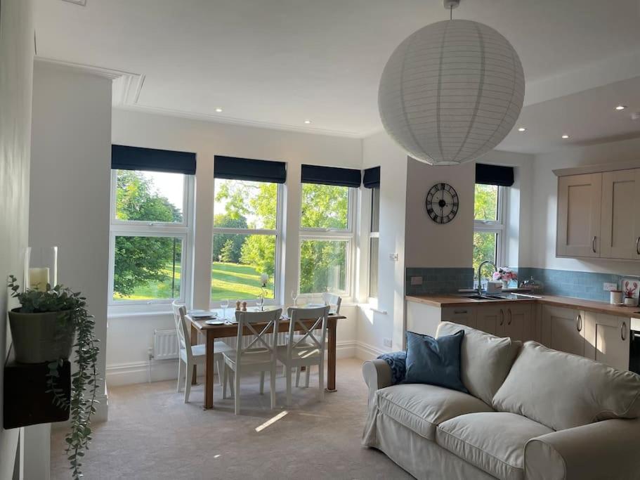 a living room with a couch and a table in a kitchen at Beautiful apartment in Harrogate, North Yorkshire in Harrogate